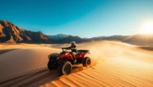 Tourists riding quad bikes across the sandy dunes of Carcross Desert in Canada, surrounded by mountains and green lakes
