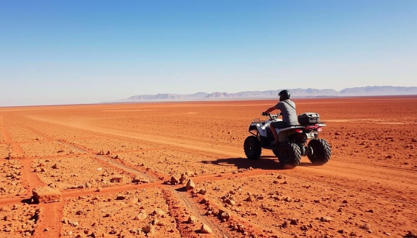 Adventurous tourist riding a quad bike across the rugged terrain of Eritrea's Danakil Depression under a bright sun
