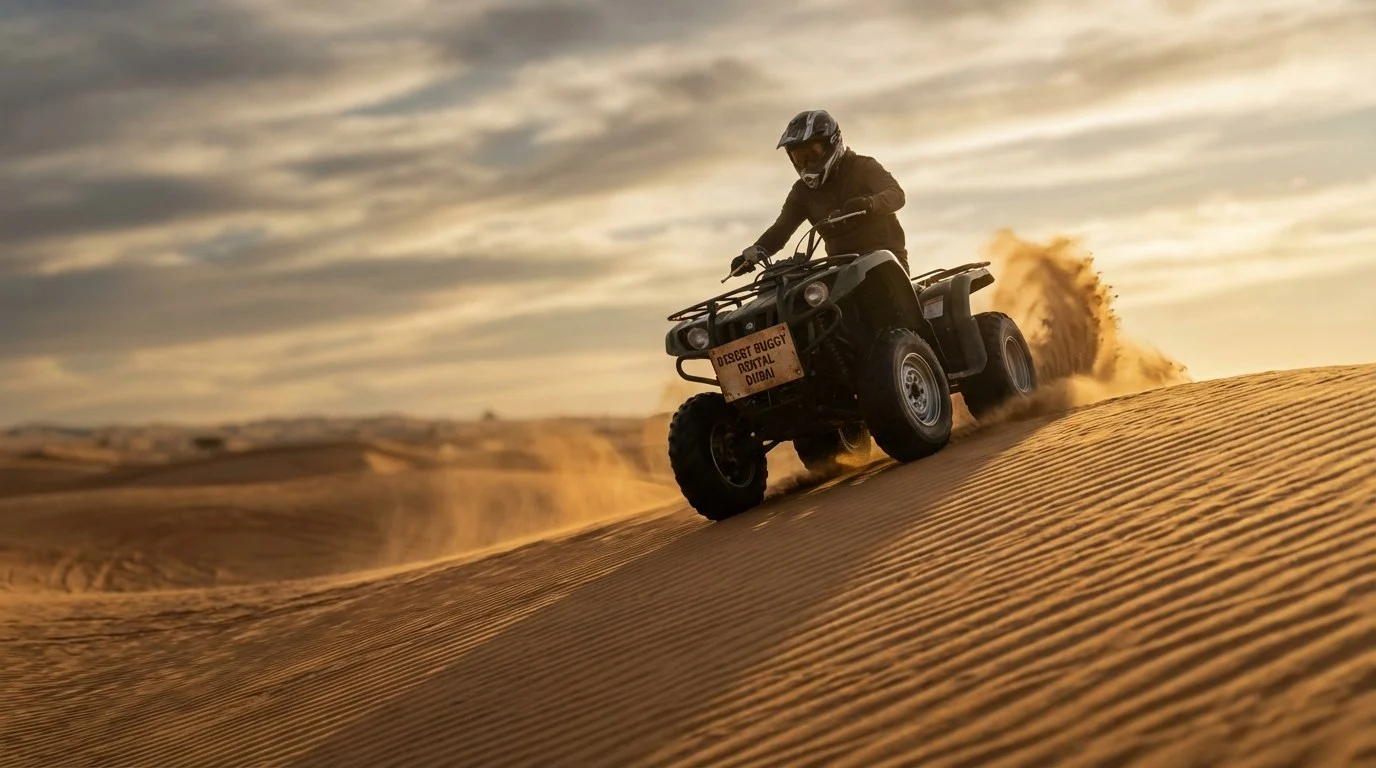 Tourists riding quad bikes through the desert dunes of Ras Al Khaimah with a guide leading the way