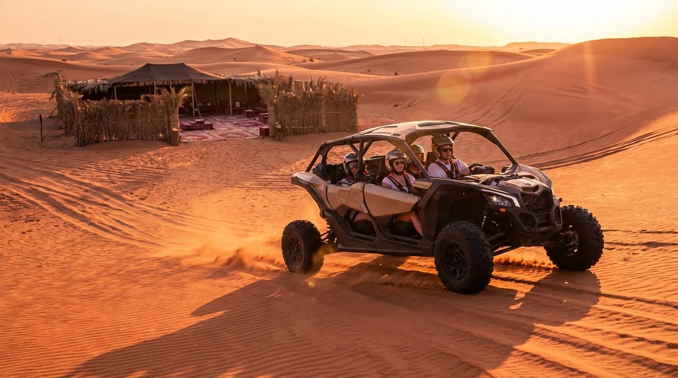 Tourists driving dune buggies in a convoy across the red sand dunes of Dubai's Lahbab desert at golden hour